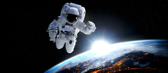 Astronaut spaceman do spacewalk while working for space station in outer space . Astronaut wear...