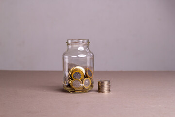 Dominican coin money in a glass jar. Saving the financial concept
