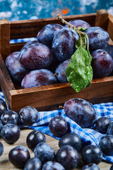 Garden plums scattered through wooden table