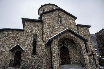 Fototapeta na wymiar gray stone Christian church in the mountains in the Caucasus 