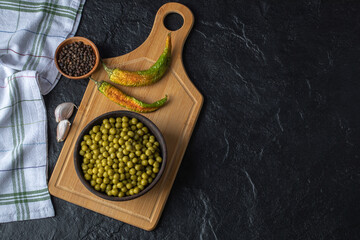 Bowl marinated olives. Spices on wooden board