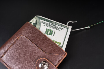 A fishing hook attached to a dollar bill in a wallet. Risk, theft, crime. business idea