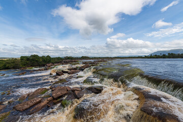 Fototapeta na wymiar View of waterfalls falling on the lagoon in Canaima National Park (Bolivar, Venezuela).