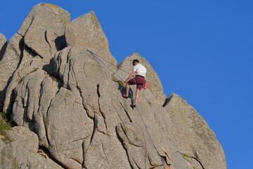 Climbing on a rock in Brittany. France