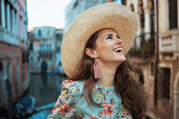 happy trendy woman in floral dress enjoying promenade