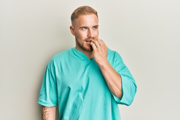 Young caucasian man wearing casual clothes looking stressed and nervous with hands on mouth biting...