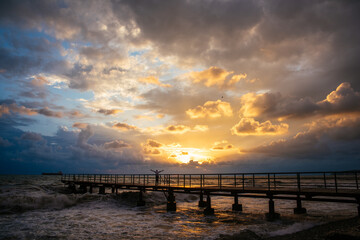 Fototapeta premium sunset over the sea and pier