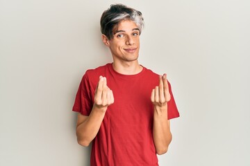 Young hispanic man wearing casual clothes doing money gesture with hands, asking for salary payment, millionaire business