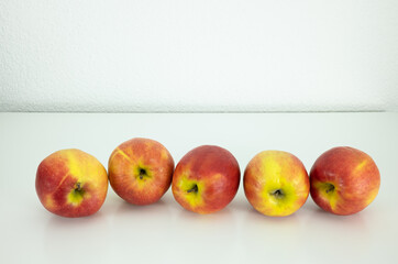 Five ripe apples on the white background