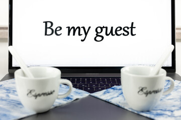 Cups of coffee on the laptop saying Be my guest