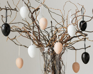 Colored easter eggs on tree branches in vase