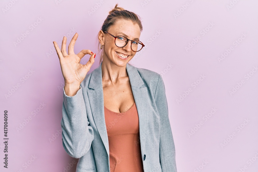 Sticker beautiful caucasian woman wearing business jacket and glasses smiling positive doing ok sign with ha