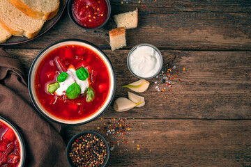 Culinary background with Russian borscht on a wooden background.