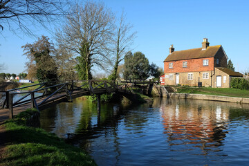 Fototapeta na wymiar Stoke Lock Cottage on the River Wey navigation, Guildford, Surrey, UK