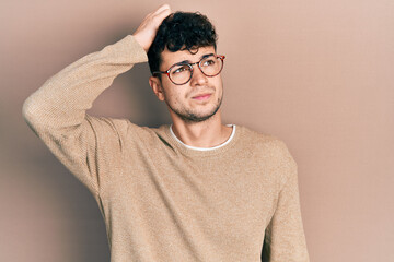 Young hispanic man wearing casual clothes and glasses confuse and wondering about question....