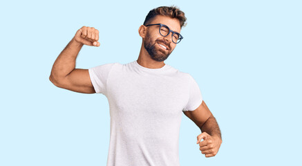 Young hispanic man wearing casual clothes and glasses stretching back, tired and relaxed, sleepy...