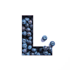 Letter L of English alphabet made of blueberries and paper cut isolated on white. Bilberry typeface