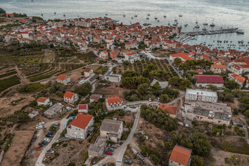 Aerial drone shot of adriatic sea Komiza town on Vis Island in Croatia summer sunrise