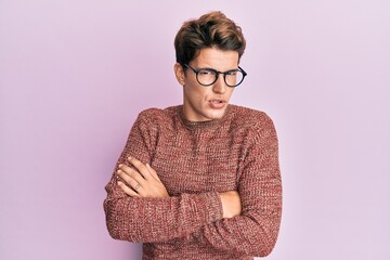 Handsome caucasian man wearing casual sweater and glasses skeptic and nervous, disapproving...