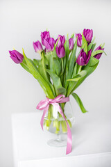 A bouquet of lilac tulips in a vase . Bouquet of tulips. Flowers in a vase. A greeting card. Valentine's day. March 8. Mother's Day. Copy space