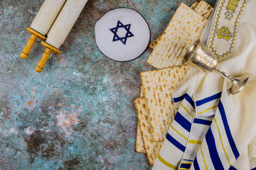 Pesach Passover symbols of great Jewish holiday traditional matzah, kippah and tallit, torah scroll
