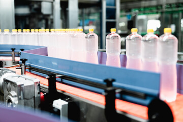 Bottling factory - Juice bottling line for processing and bottling lemon juice into bottles. Selective focus.