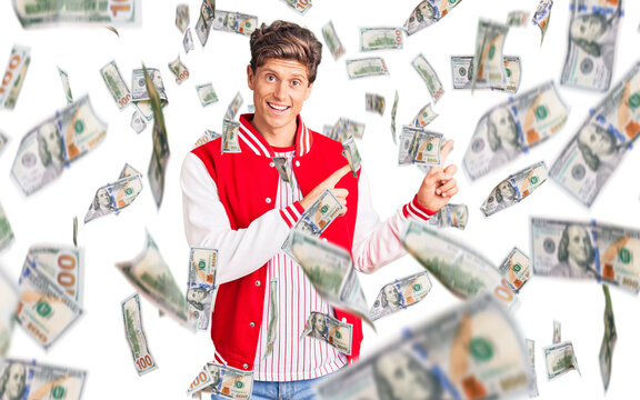 Young handsome man wearing baseball uniform smiling and looking at the camera pointing with two hands and fingers to the side.