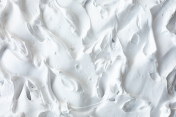 The texture of the lush whipped cream. Delicate creamy  volumetric white consistency. Culinary white background