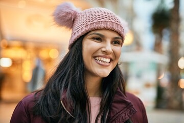 Young hispanic girl smiling happy standing at the city.