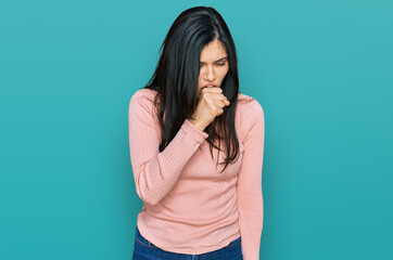 Young hispanic woman wearing casual clothes feeling unwell and coughing as symptom for cold or...