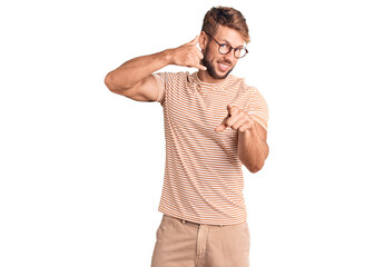 Young caucasian man wearing casual clothes and glasses smiling doing talking on the telephone...