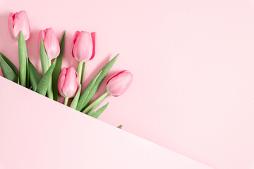 Fototapeta premium Beautiful pink tulips on pastel pink background. Concept Women's Day, March 8. 8th march. Flat lay, top view, copy space