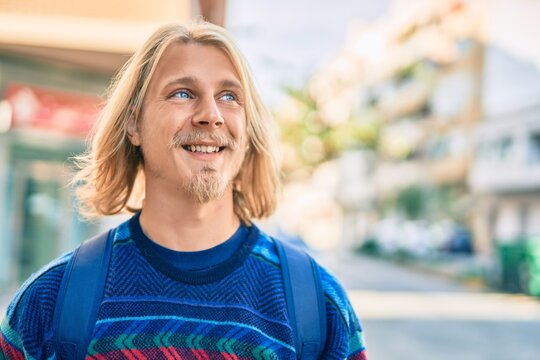 Young scandinavian student man smiling happy standing at the city.