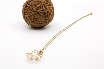 Golden chain necklace with pearl pendant on white background. Jewel Design.