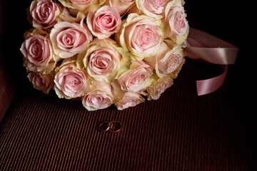 Wedding bouquet with rings on a dark background