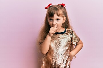 Little caucasian girl kid wearing festive sequins dress feeling unwell and coughing as symptom for cold or bronchitis. health care concept.