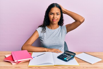 Young african american girl accountant working at the office confuse and wonder about question....