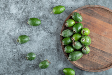 Fresh feijoa fruits on a wooden plate