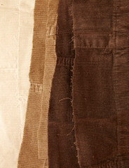 Many cotton traditional corduroy retail, with tattered around as backdrop, against white background