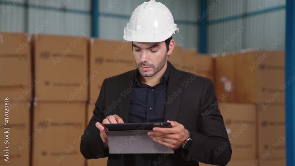 Poster factory manager using tablet computer in warehouse or factory . industry and supply chain management