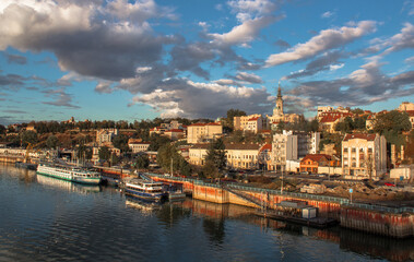 Naklejka na ściany i meble View of the city of Belgrade from Branko's bridge, and across the river Sava. Panorama of the city on a beautiful day with fantastic clouds.