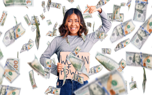 Young beautiful mixed race woman holding woman power banner pointing finger to one self smiling happy and proud