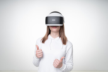 Portrait of a woman, using VR headset and showing thumbs up