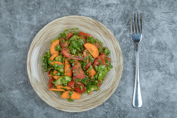 A wooden plate of delicious vegetable salad