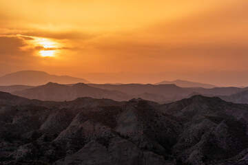 Fototapeta na wymiar Sunset landscape over the badlands of the Granada Geopark.