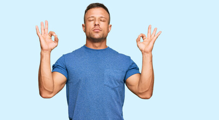 Handsome muscle man wearing casual clothes relax and smiling with eyes closed doing meditation gesture with fingers. yoga concept.