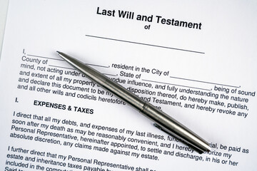 Last will and testament document form and silver pen.