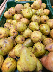 Green pears harvest. Pears in a basket on shelf in supermarket may use as background close up