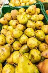 Yellow pears harvest. Pears in a basket on shelf in supermarket may use as background close up