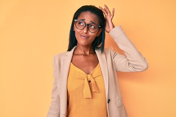 Young african american woman wearing business clothes confuse and wonder about question. uncertain...
